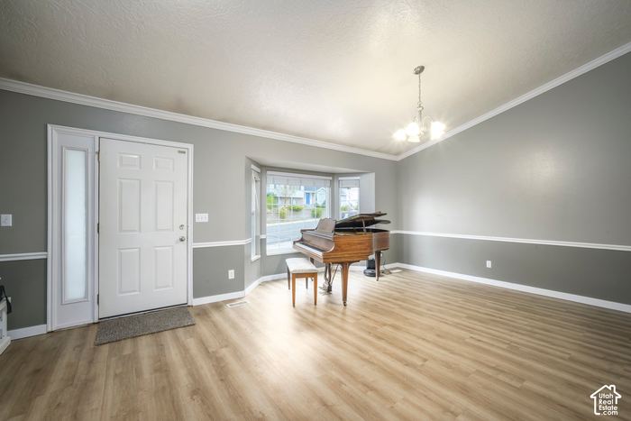 Formal living room with hardwood floors and a bay window